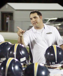 Coach Perez talks to his team before a game. As the new head coach, there are many goals he would like to achieve for the season.