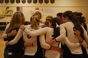 Coach Stegenga huddles with her team before their match against the Sickle's Griffons. She is looking forward to a great season and being able to establish good relatioinships with all the girls.
