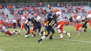 Mike Norder (#30) takes a hand off in the backfield against Plant City. Norder was the starting fullback for the Warriors this season. 
